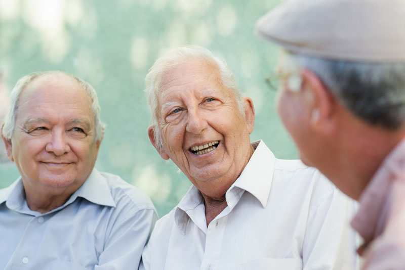 dental patient speaking to others about getting dental implants.