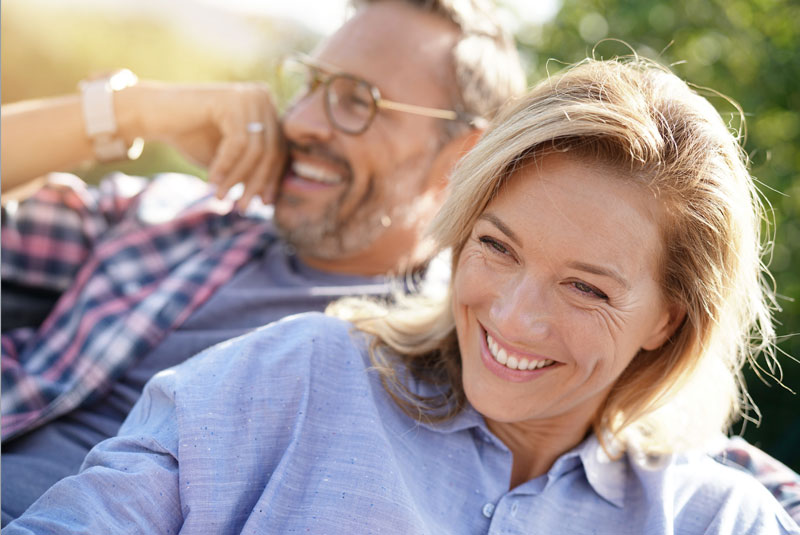 full arch dental implant patients smiling together.