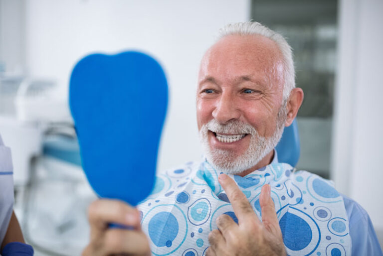 a dental implant patient smiling after the procedure.