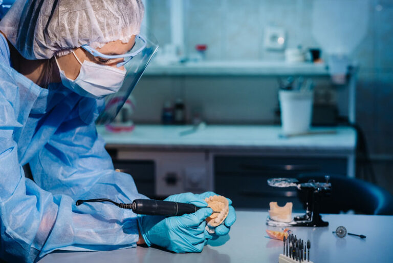 a prosthodontist milling a dental implant restoration in a dental lab.