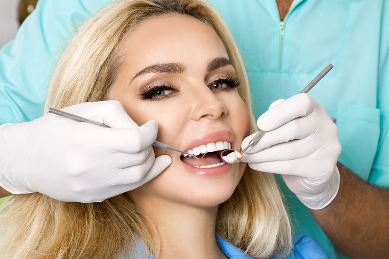 a full mouth dental implant patient and an implant dentist during a procedure.