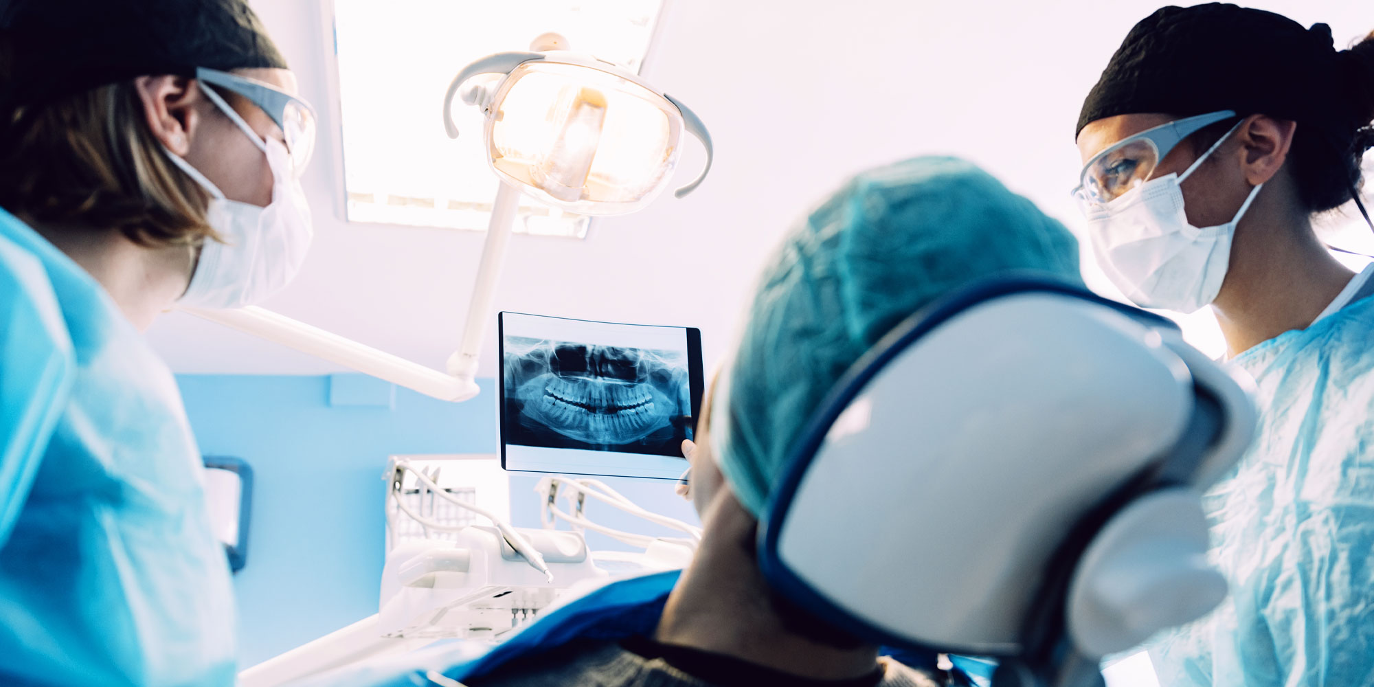 dentist-performing-full-mouth-dental-implants-procedure