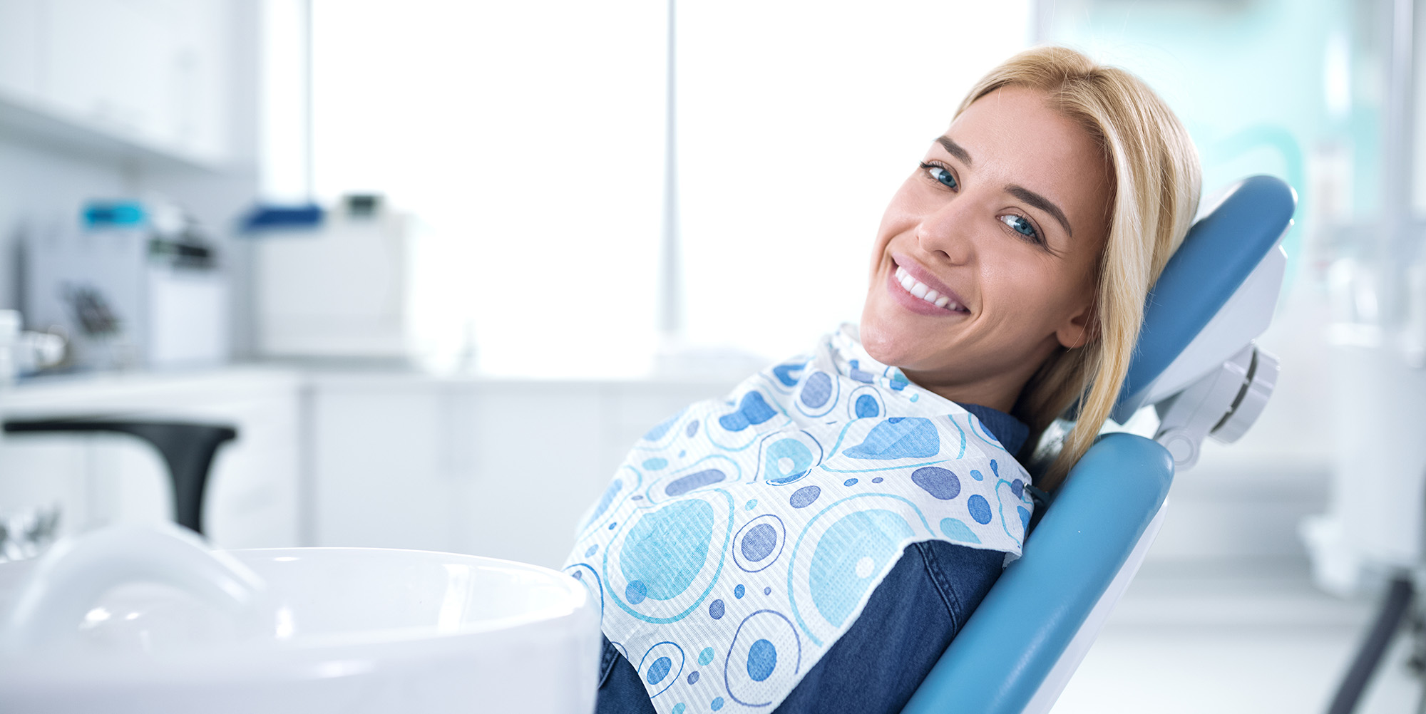 Smiling and satisfied patient in a dental office